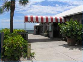 Exterior of Ocean Grill with red and white awning